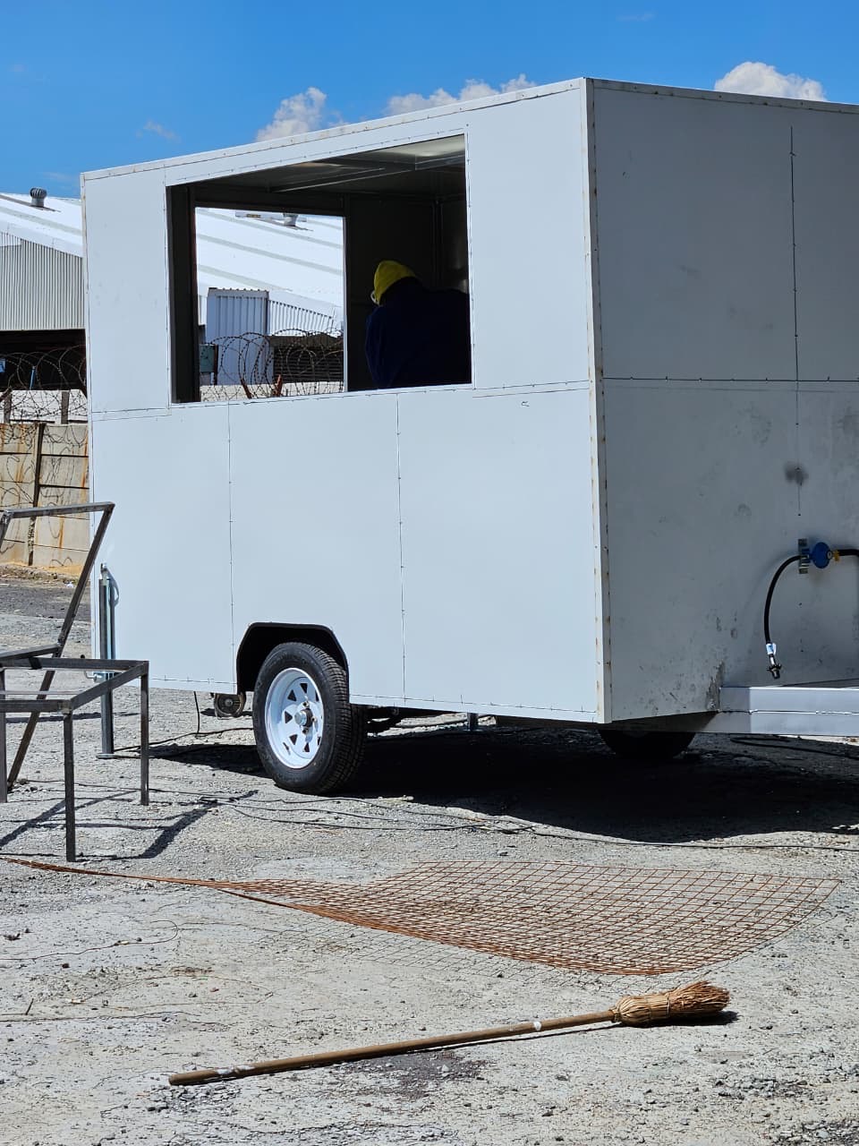 White mobile kiosk trailer being fitted out