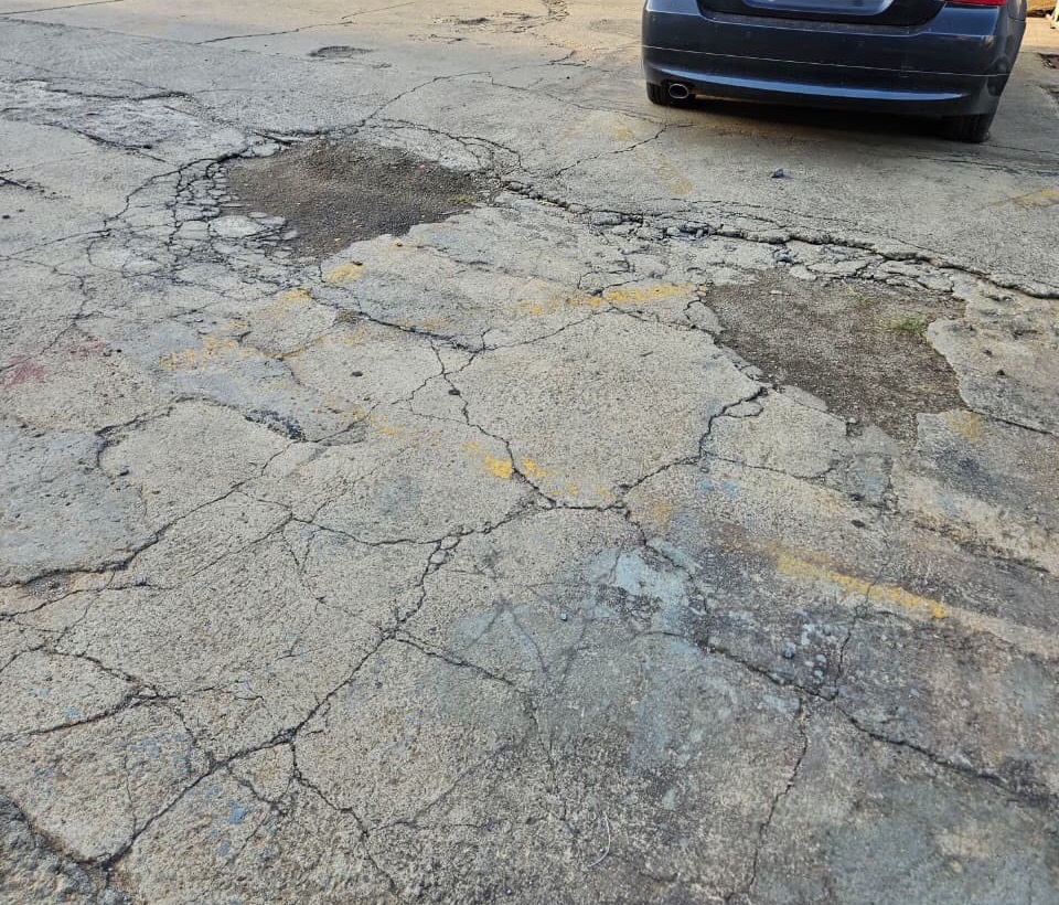 Patched potholes in a paved yard